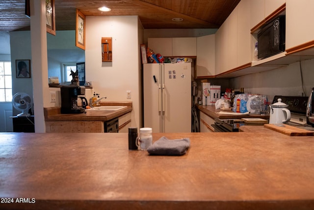 kitchen with black appliances, a sink, recessed lighting, white cabinets, and wood ceiling