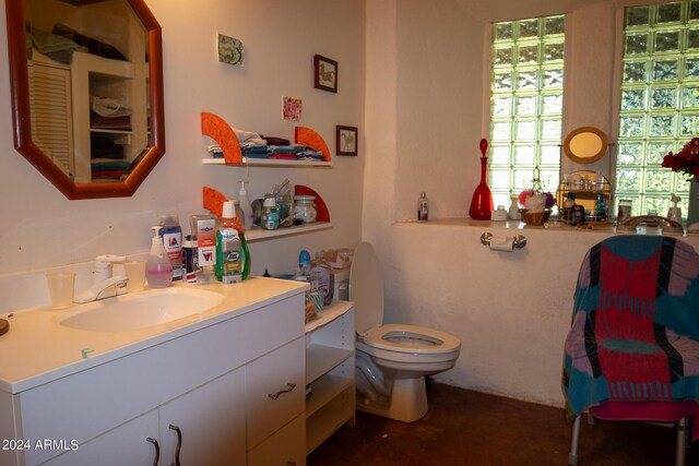 bathroom featuring toilet and vanity