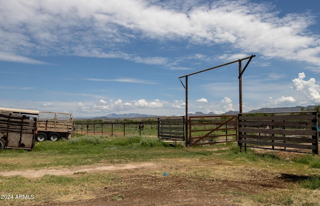view of yard with a gate, a rural view, a mountain view, and fence