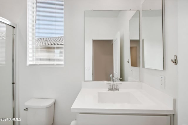 bathroom featuring toilet and vanity