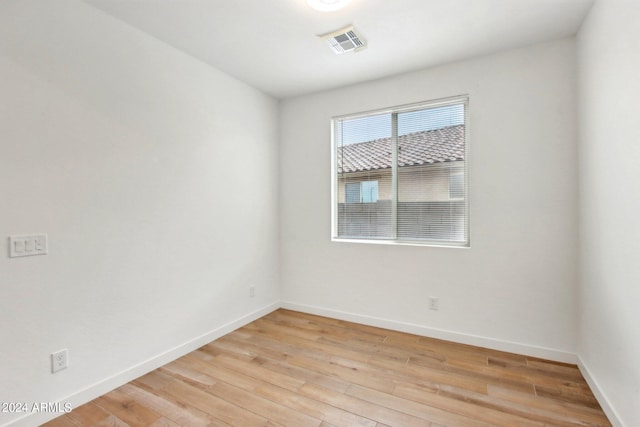 unfurnished room with light wood-type flooring