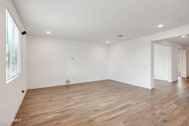 empty room featuring light hardwood / wood-style flooring and a wealth of natural light