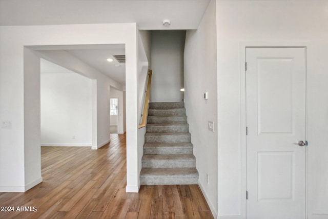 stairway with hardwood / wood-style flooring