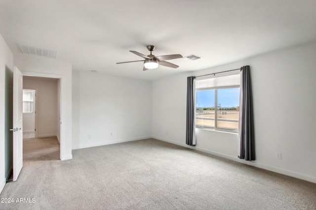 unfurnished room with ceiling fan and carpet flooring