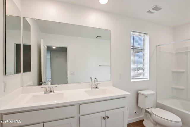 full bathroom with dual vanity, toilet, and shower / tub combination