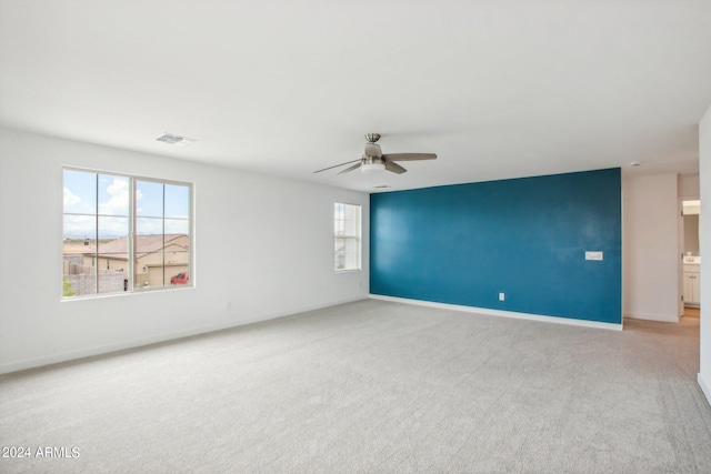 carpeted empty room with ceiling fan