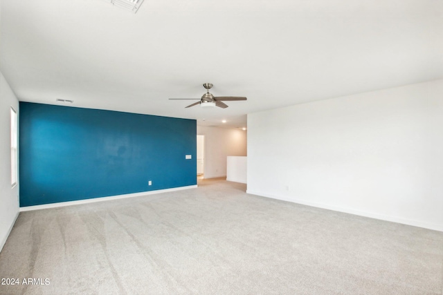 spare room featuring carpet and ceiling fan