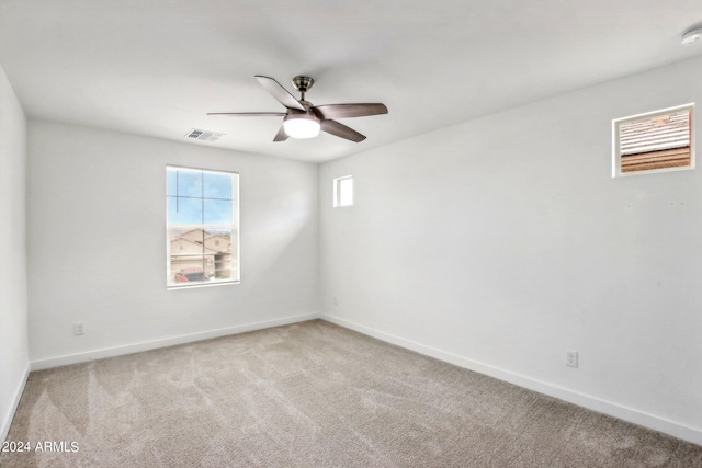 spare room with carpet flooring and ceiling fan