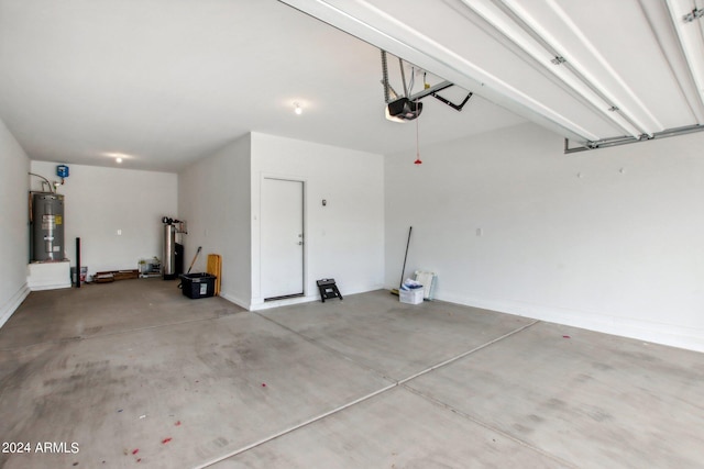 garage featuring electric water heater and a garage door opener