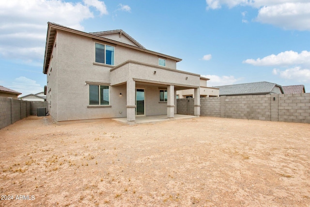 rear view of property featuring a patio and central AC