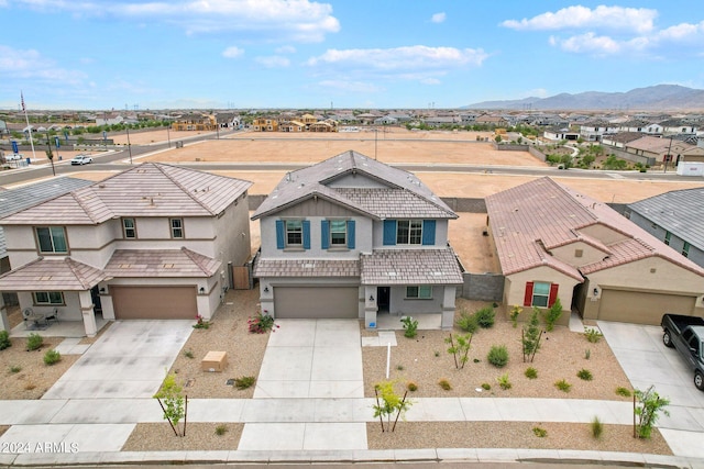 view of front of property with a mountain view and a garage