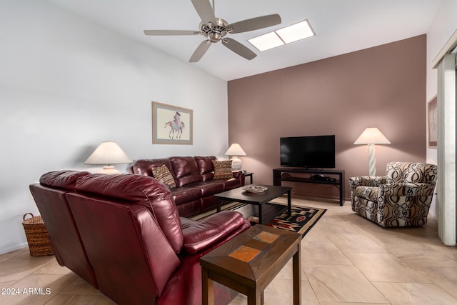 living room featuring ceiling fan and vaulted ceiling