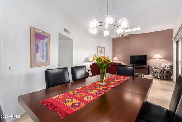 dining space with light tile patterned floors and a towering ceiling