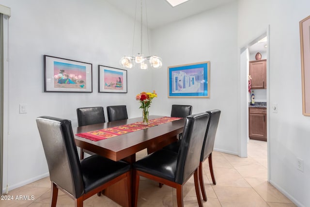 dining area featuring light tile patterned floors and a chandelier