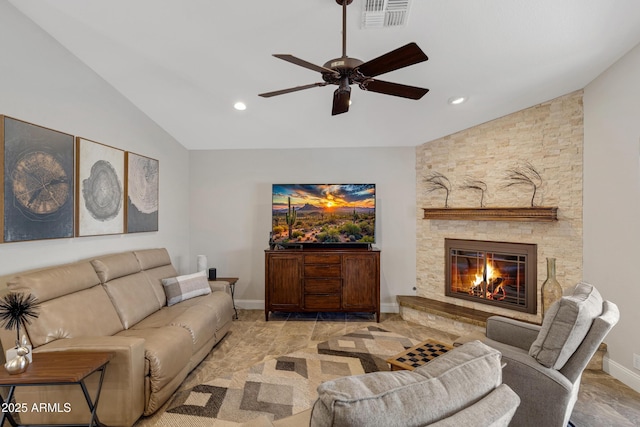 living room with baseboards, visible vents, vaulted ceiling, and a stone fireplace