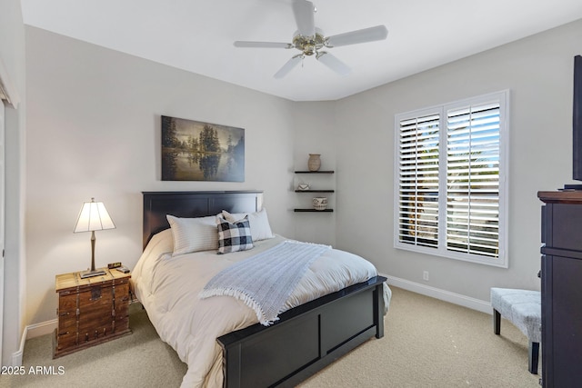 bedroom with baseboards, a ceiling fan, and light colored carpet