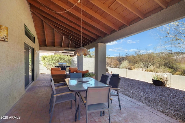 view of patio / terrace with outdoor dining space, a fenced backyard, and a grill