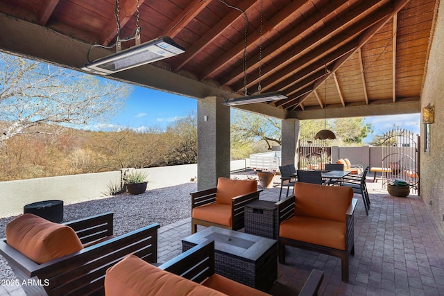 view of patio with outdoor dining space, outdoor lounge area, a fenced backyard, and a gazebo