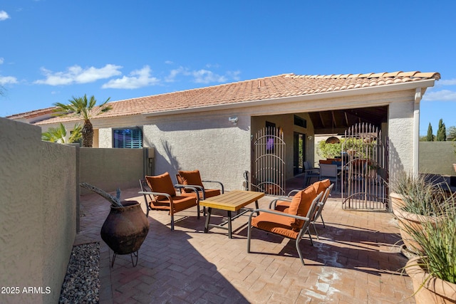 view of patio featuring a gate, fence, and outdoor lounge area