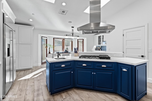 kitchen featuring blue cabinetry, a kitchen island with sink, stainless steel appliances, white cabinets, and island exhaust hood