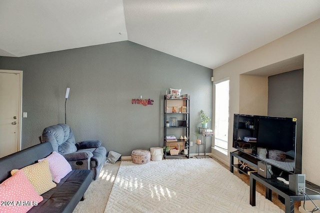 living room with vaulted ceiling and baseboards