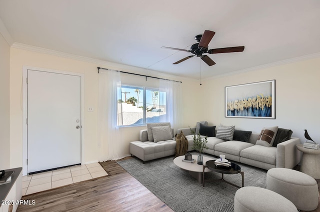 living room with ceiling fan, ornamental molding, and light hardwood / wood-style flooring