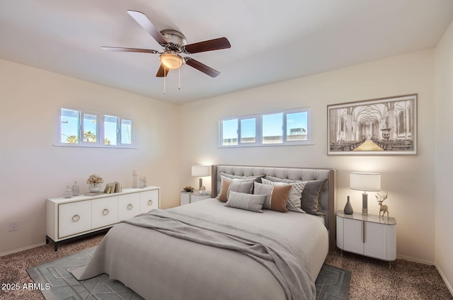 bedroom with ceiling fan, multiple windows, and carpet flooring