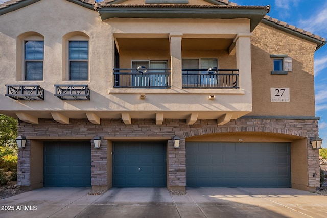 320 N 168th Dr, Goodyear, AZ 85338 - multi unit property featuring stone siding, a balcony, stucco siding, and an attached garage