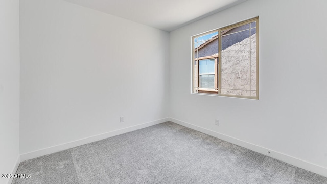 spare room with carpet flooring and baseboards