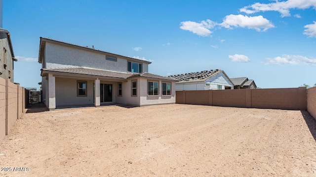back of house featuring stucco siding, a fenced backyard, and a patio