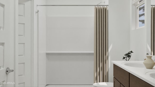 full bath featuring double vanity and a shower with shower curtain