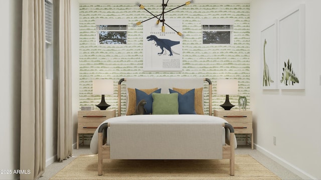 bedroom with baseboards, wallpapered walls, carpet floors, a chandelier, and an accent wall