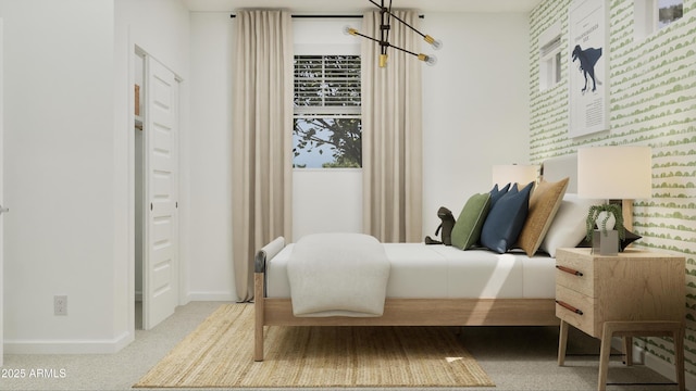 bedroom featuring baseboards, a chandelier, and carpet floors