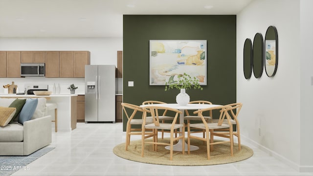dining area featuring baseboards and light tile patterned floors
