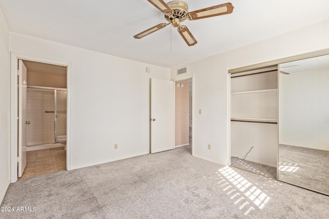 unfurnished bedroom with ceiling fan, light colored carpet, connected bathroom, and a closet