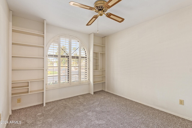 carpeted empty room featuring ceiling fan