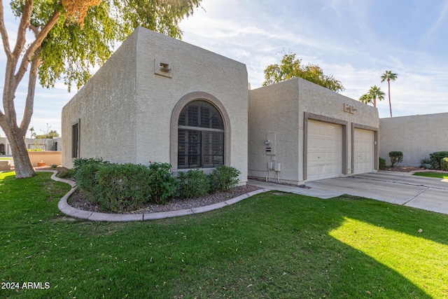 view of front of house with a front yard and a garage