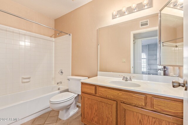 full bathroom featuring tile patterned floors, vanity, toilet, and tiled shower / bath