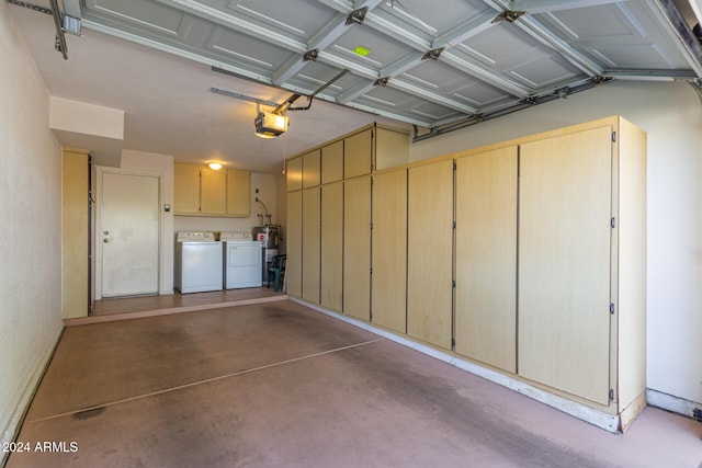 garage featuring electric water heater, washer and dryer, and a garage door opener