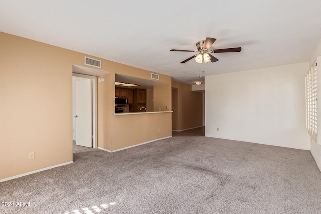 unfurnished living room featuring carpet flooring and ceiling fan