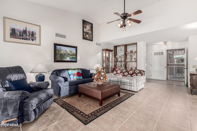 living room with ceiling fan, lofted ceiling, and light tile patterned floors