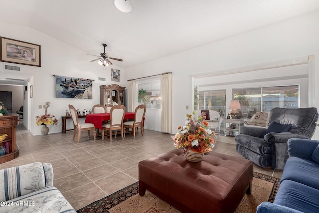 living room featuring ceiling fan, tile patterned flooring, and vaulted ceiling