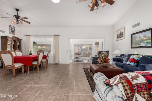 tiled living room featuring vaulted ceiling