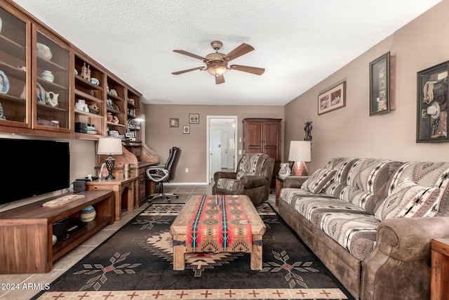 tiled living room featuring a textured ceiling and ceiling fan