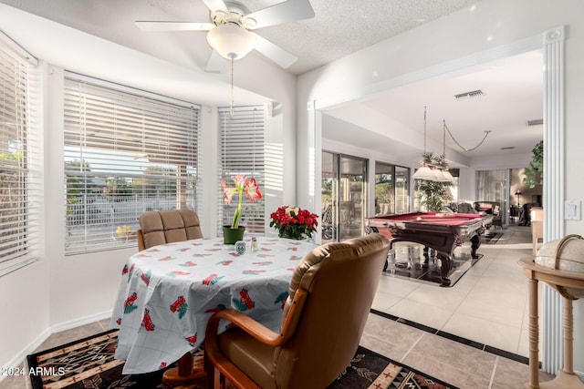 tiled dining space with ceiling fan, a textured ceiling, and pool table