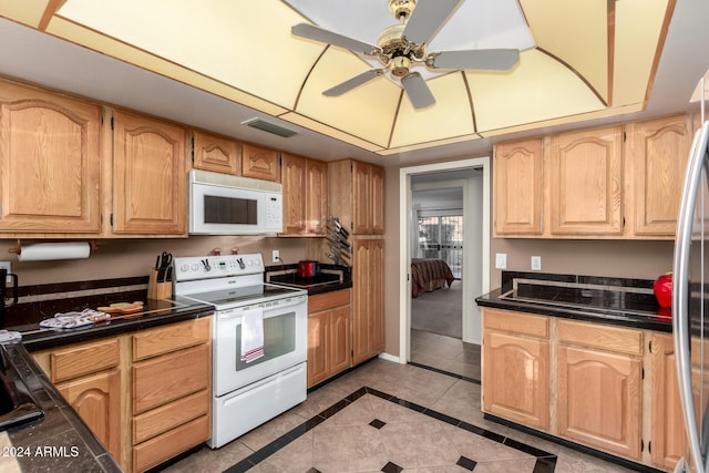 kitchen with ceiling fan, light brown cabinets, light tile patterned floors, and white appliances