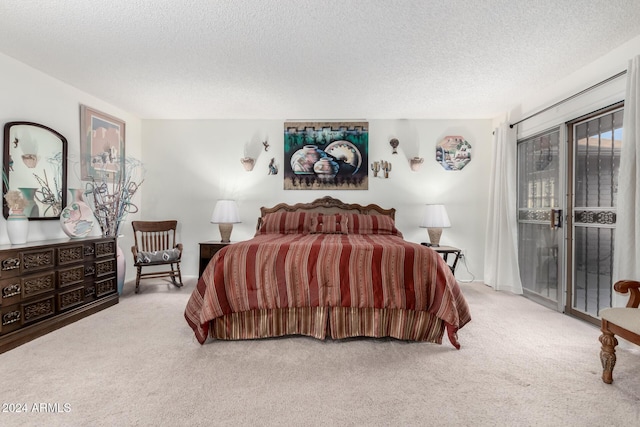 bedroom featuring access to exterior, light carpet, and a textured ceiling