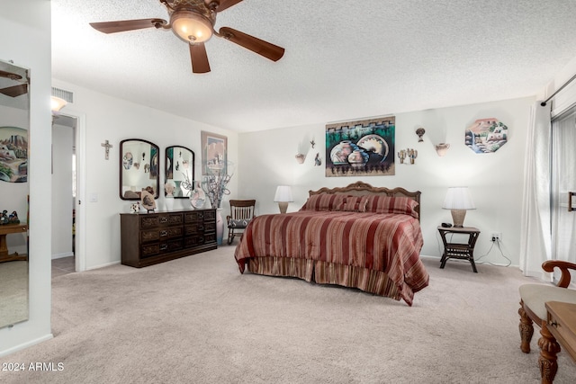 bedroom featuring light carpet, a textured ceiling, and ceiling fan