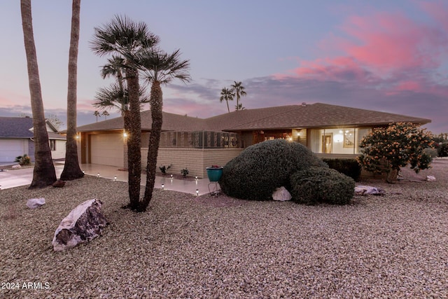 property exterior at dusk with a garage