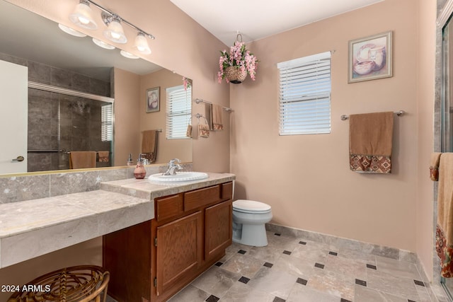 bathroom featuring vanity, toilet, and walk in shower